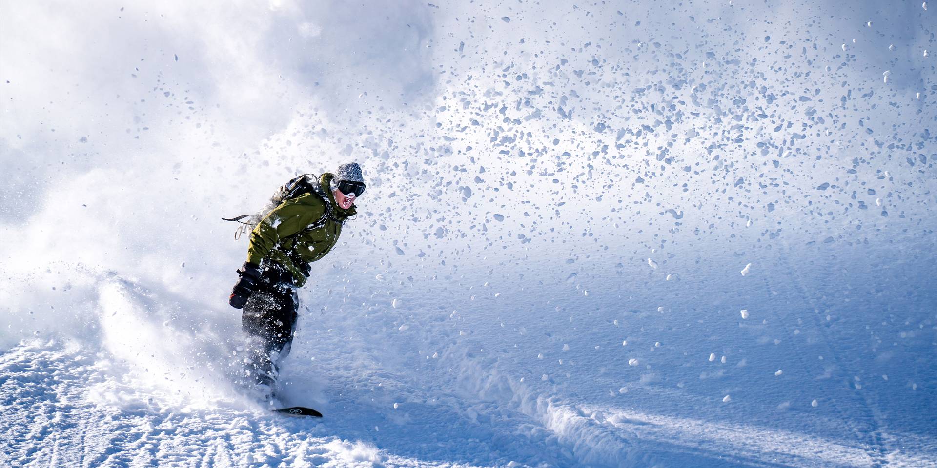 Snowboarder slashing powder