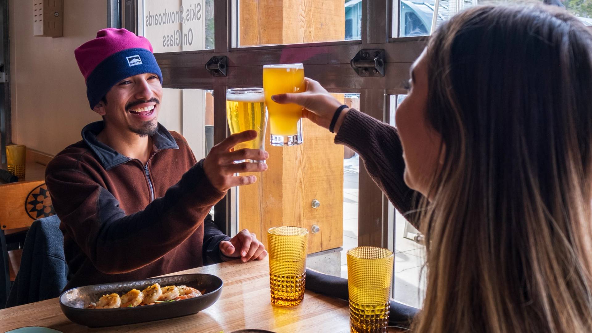 Couple drinking beers at the Milly Chalet