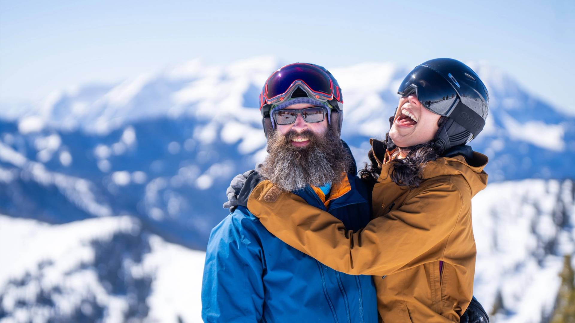 Couple smiling on the mountain top