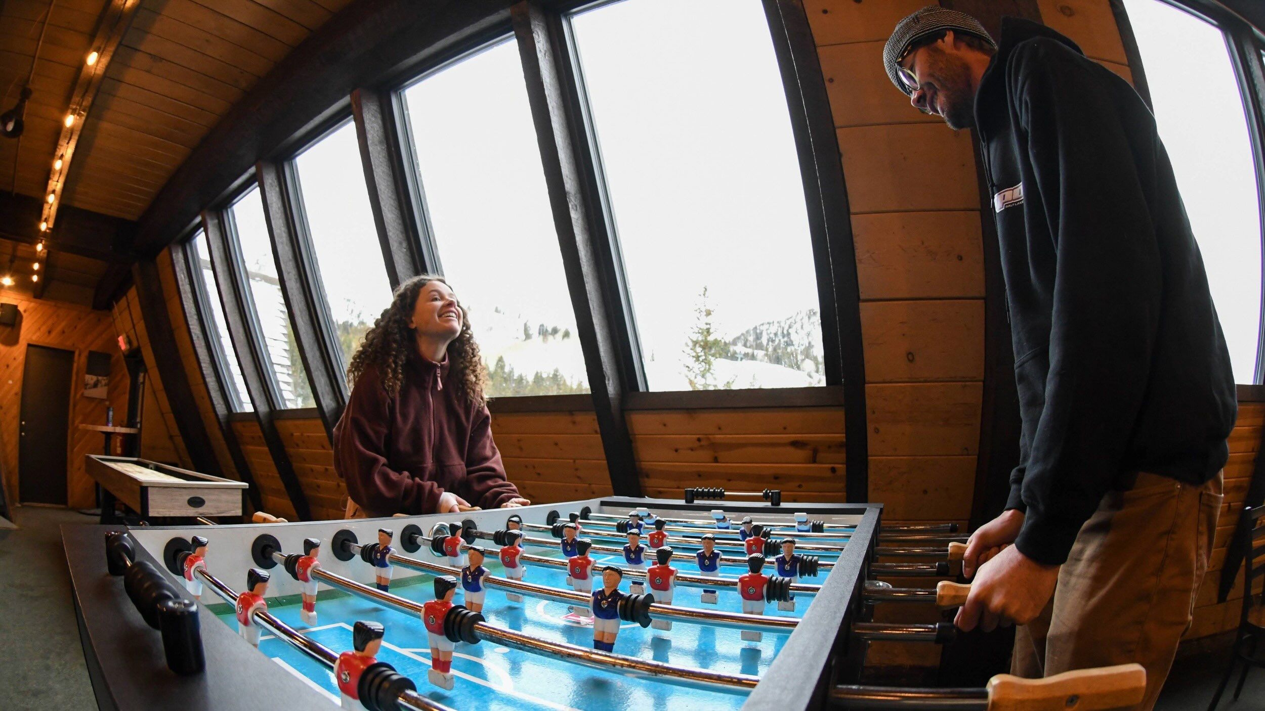 Friends at Molly Green's playing foosball Brighton Ski Resort