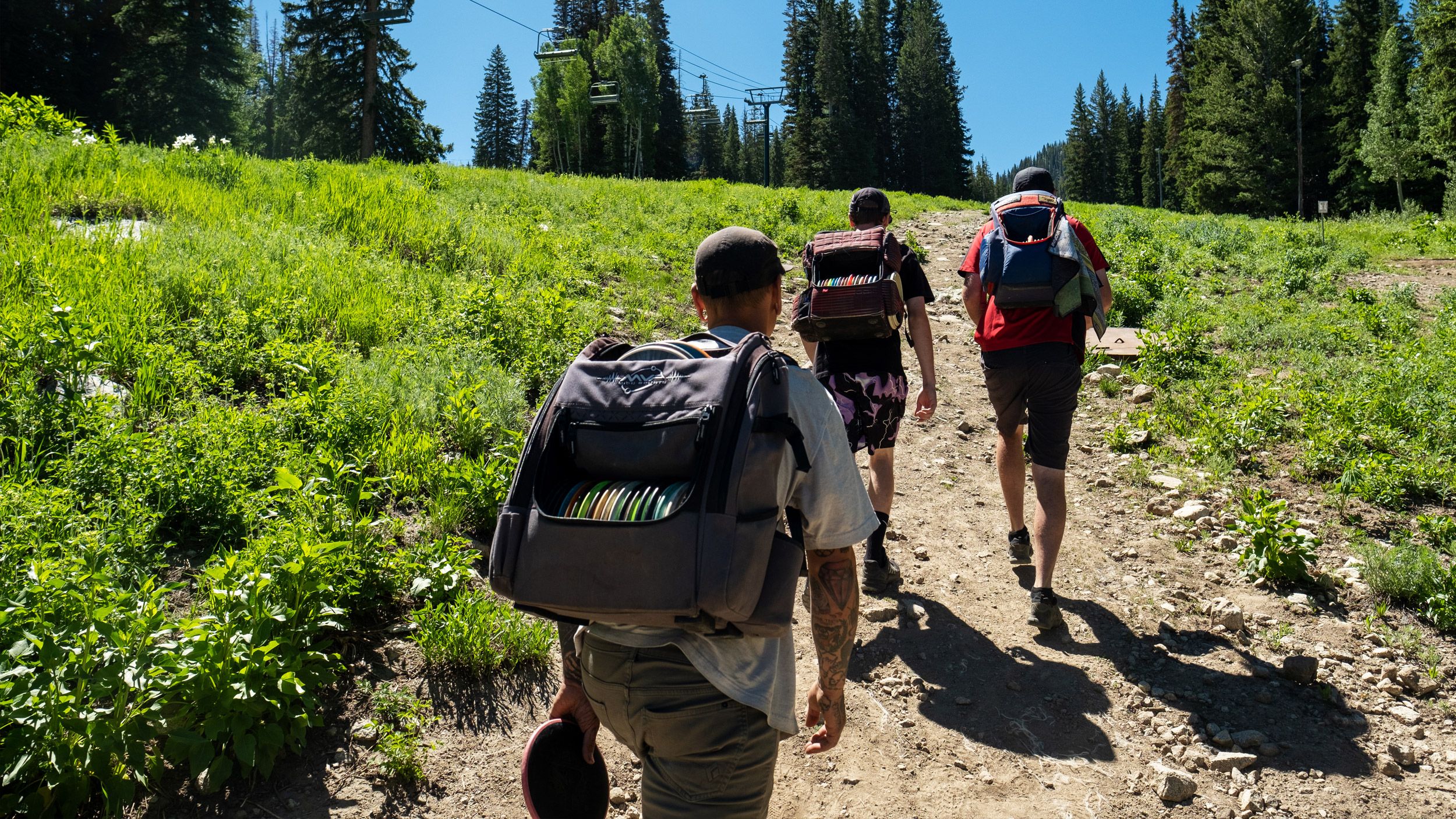 Friends playing disc gold at Brighton Ski Resort during the summer