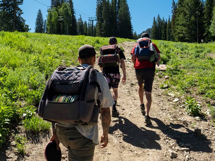 Group of friends playing disc golf together at Brighton Resort in the summer