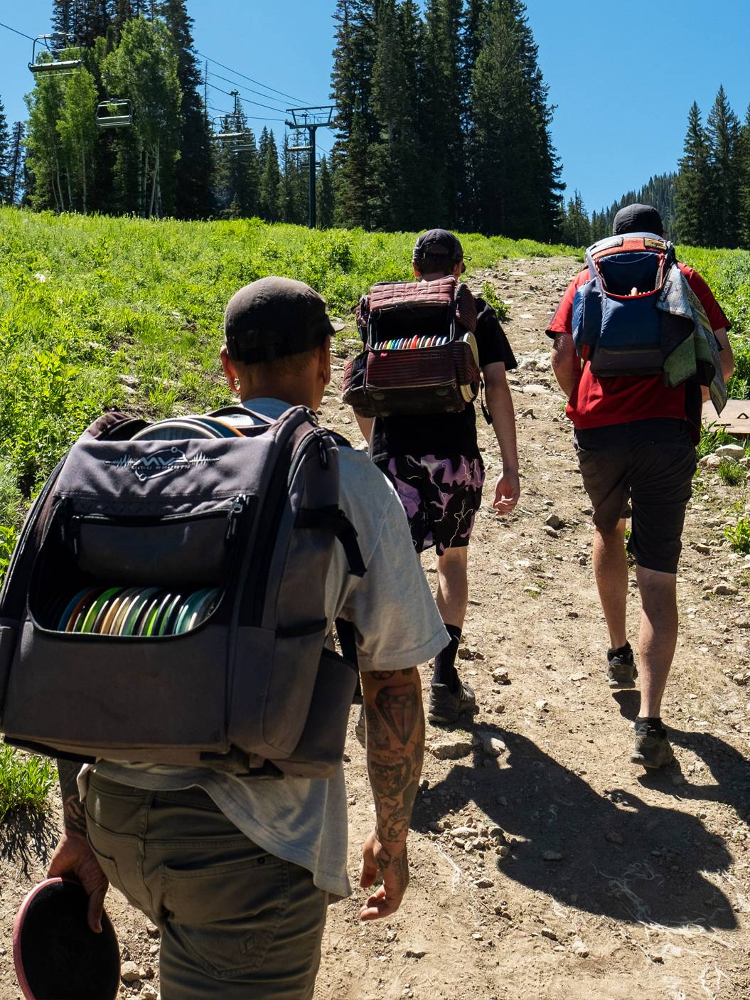Friends playing disc gold at Brighton Ski Resort during the summer