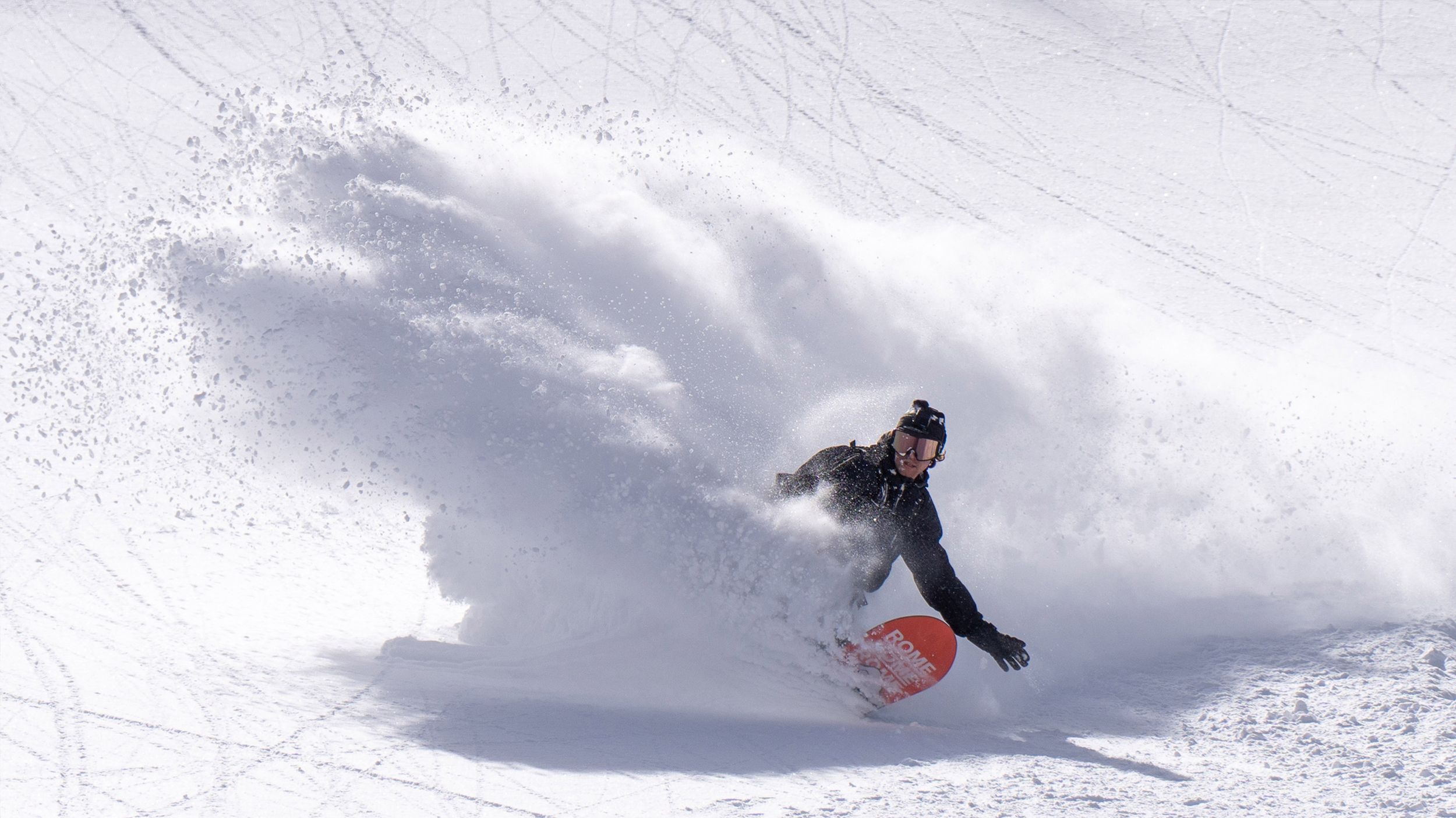 Snowboarder at Bright Resort slashing powder