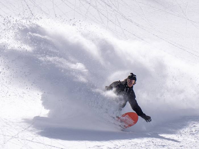 Snowboarder at Bright Resort slashing powder