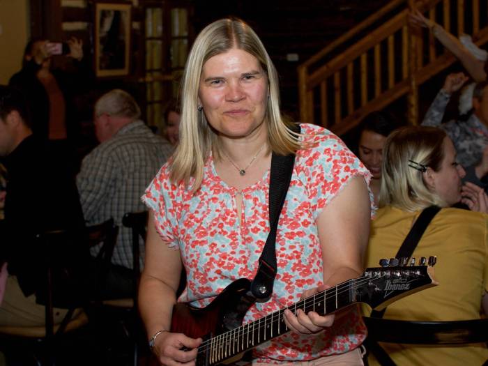 Guest playing guitar at Murder on the Mountain dinner at Brighton Resort
