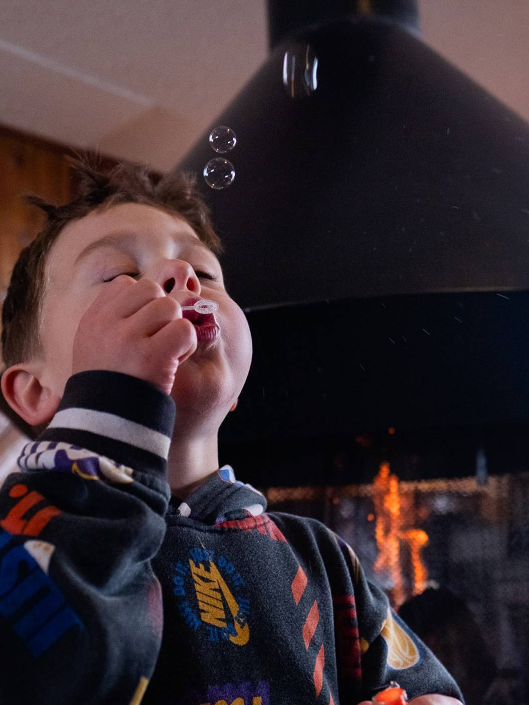 Kid blowing bubbles in the Brighton Lodge lobby