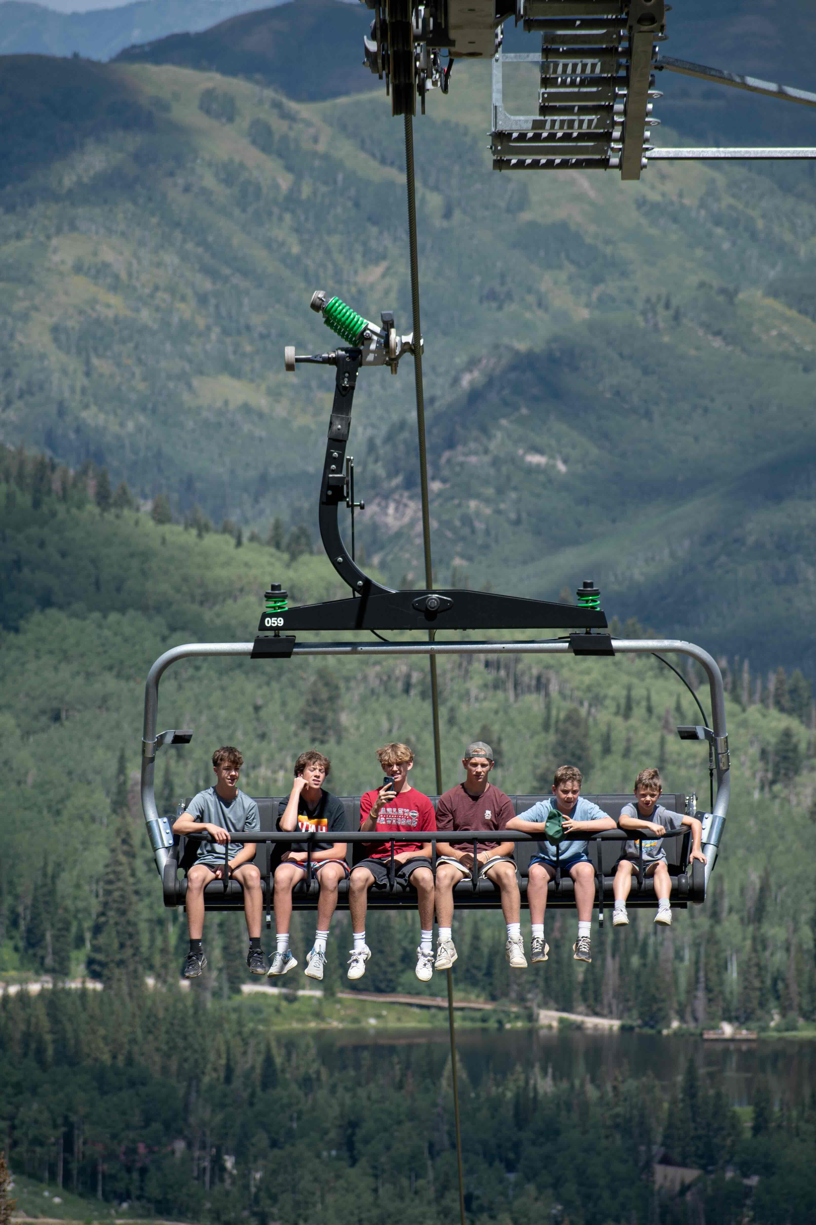 Friend group on scenic lift ride at Brighton Resort in the summer time