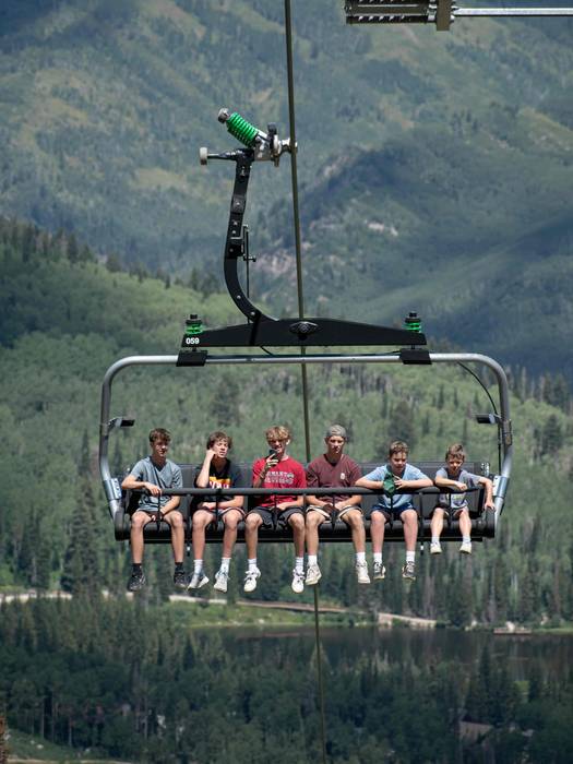 Friend group on scenic lift ride at Brighton Resort in the summer time