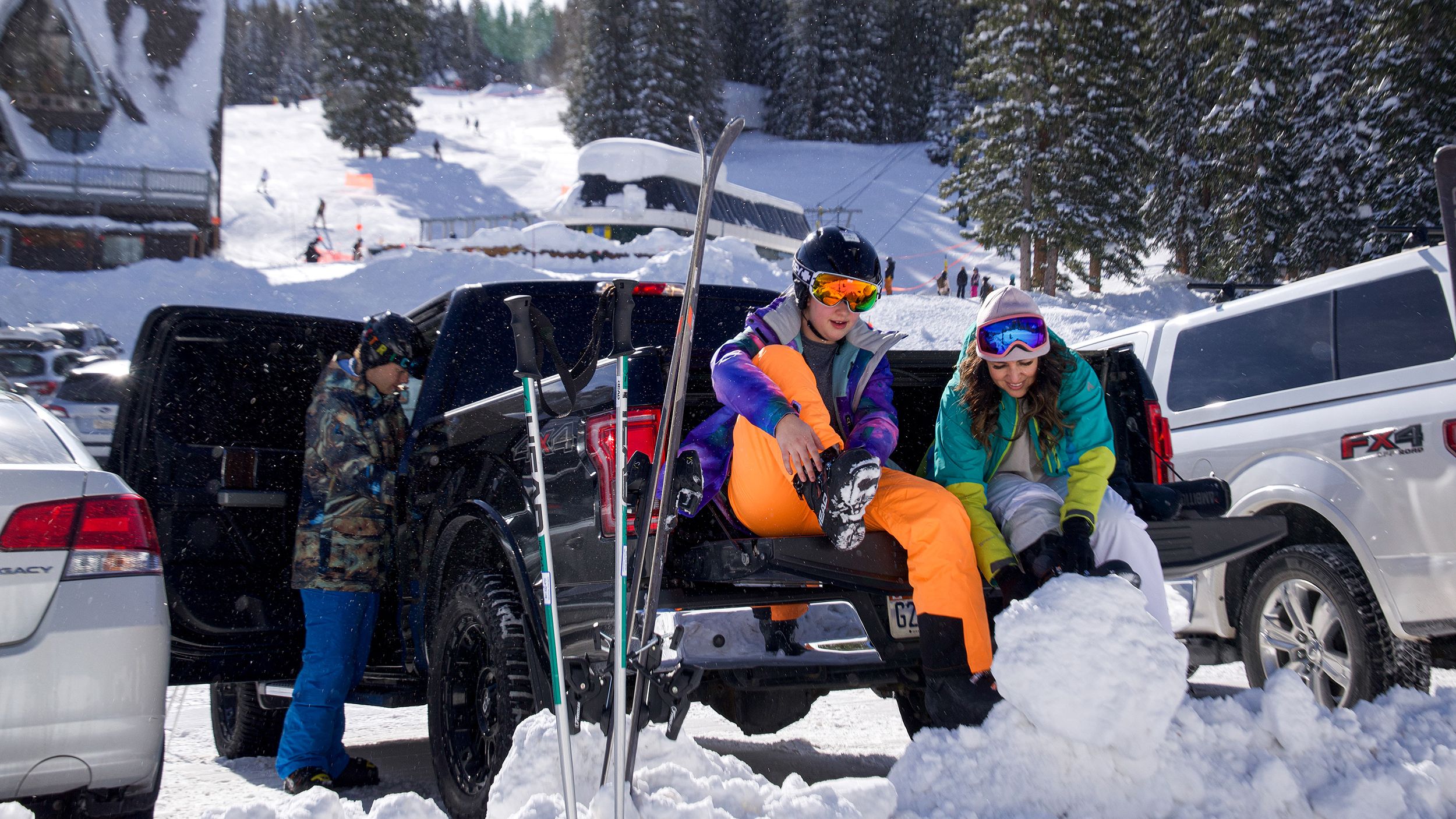 Friends putting on gear in the parking lot