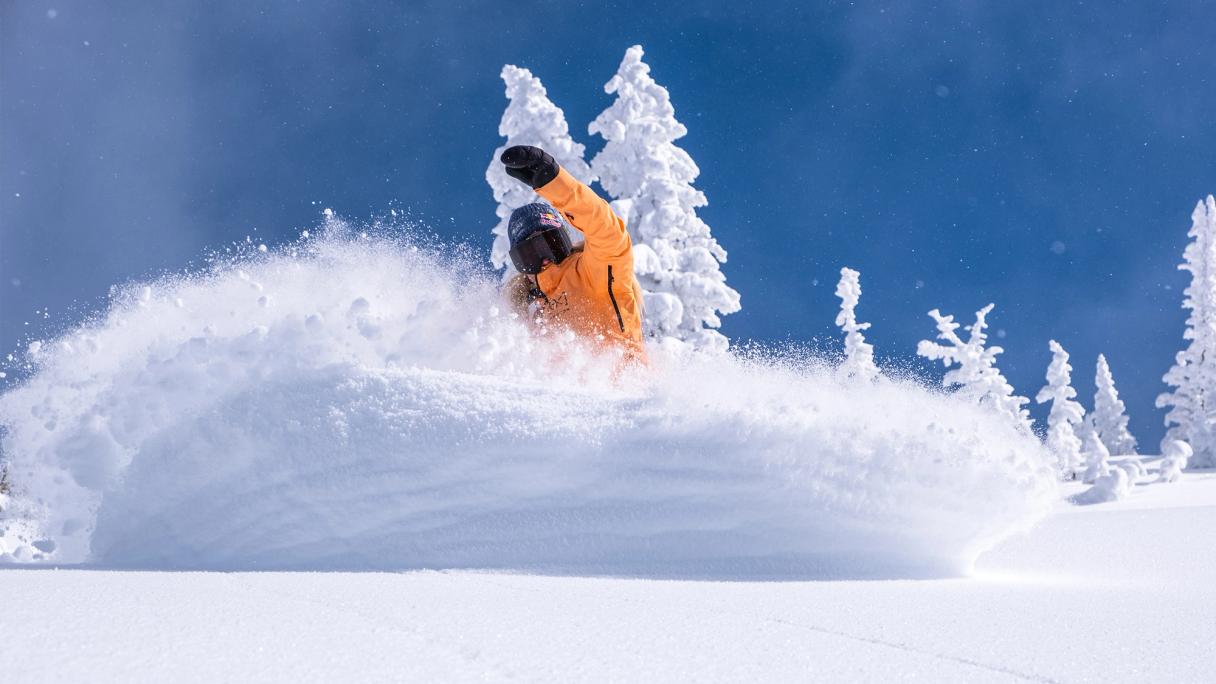 Snowboarder carving deep snow of Brighton in Utah