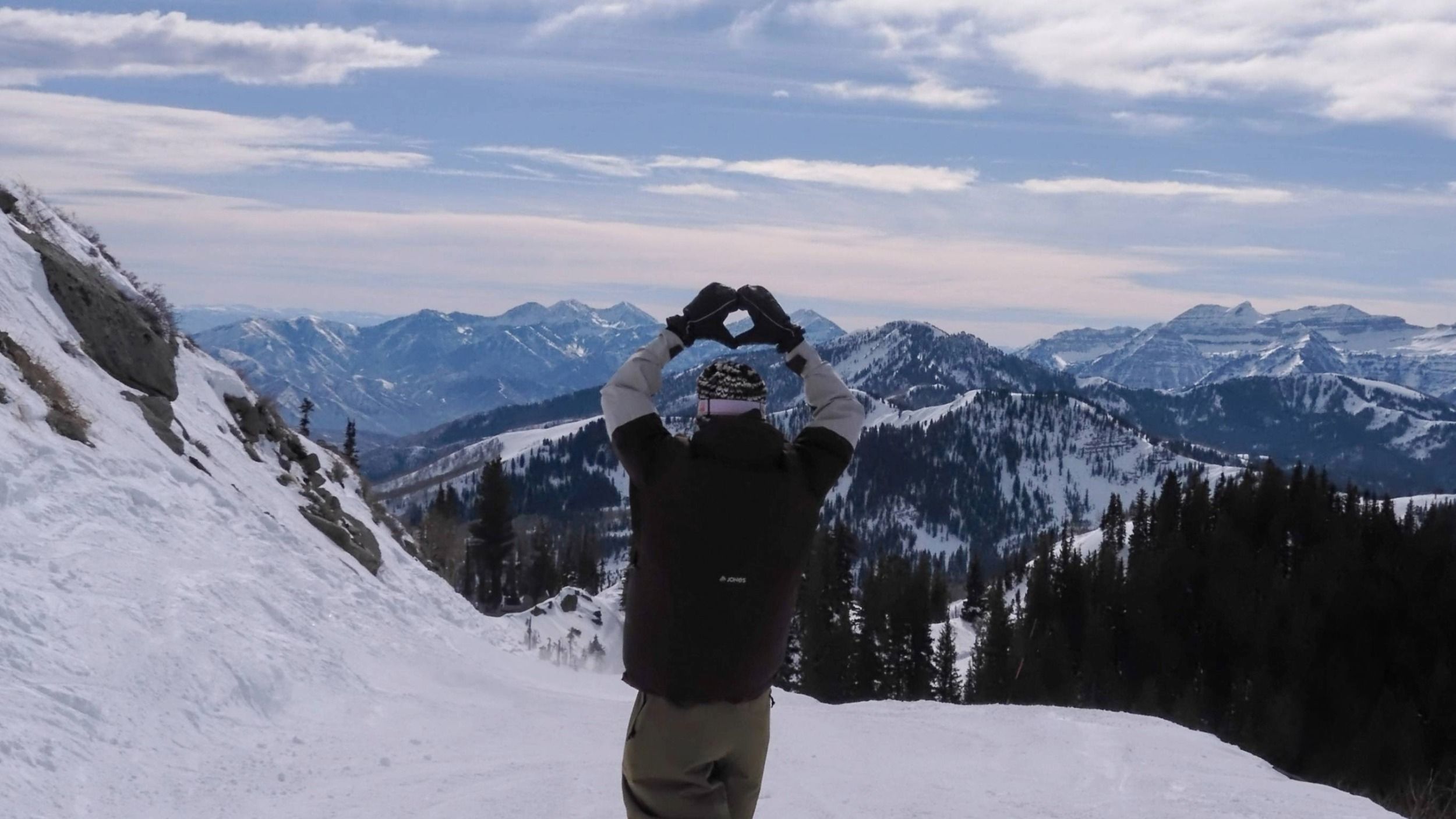 Snowboarder riding off of Great Western at Brighton Ski Resort