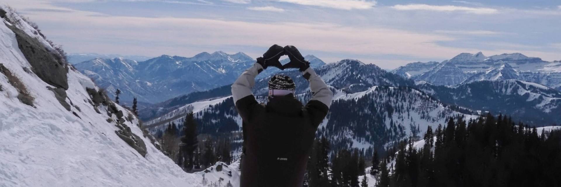 Snowboarder riding off of Great Western at Brighton Ski Resort