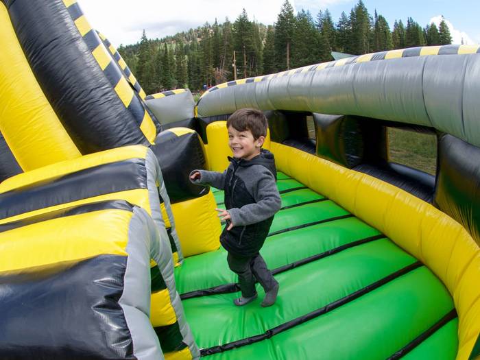 Kid playing in the fun houses at Brighton Resort in the summer