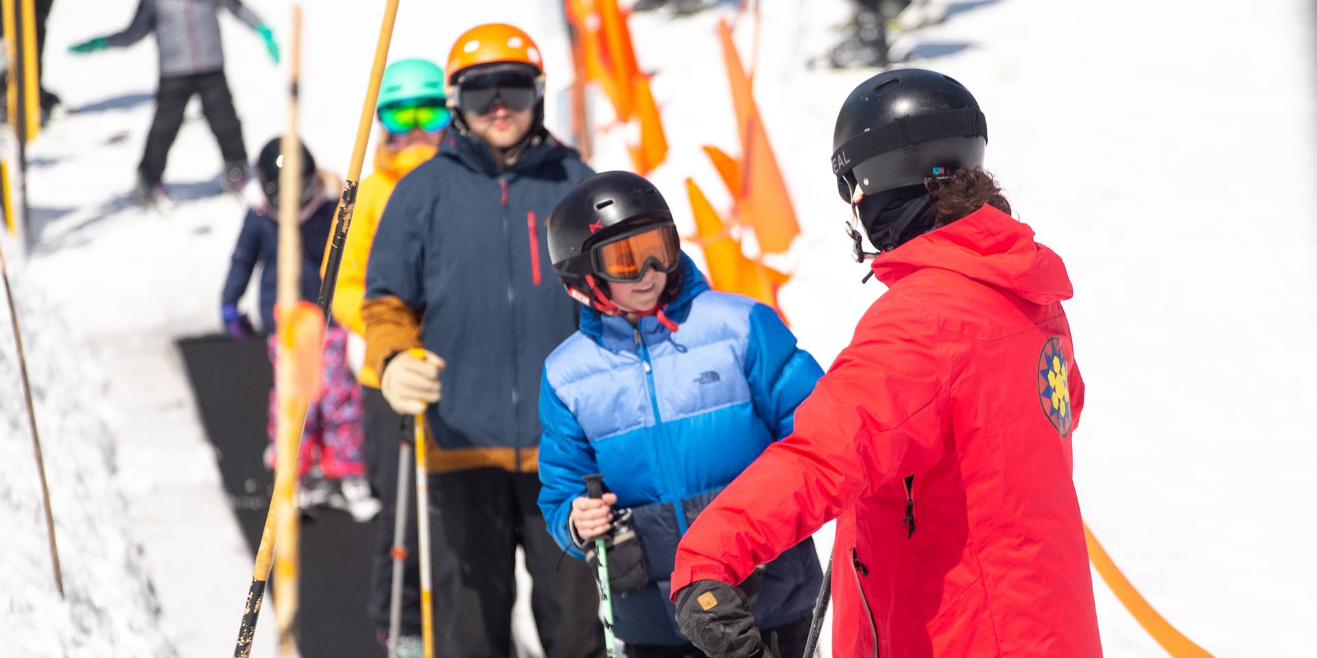 Ski instructor on magic carpet with kid