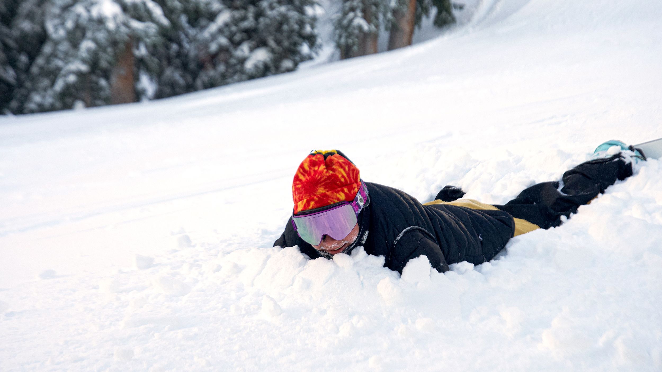 Snowboarder face first in the snow