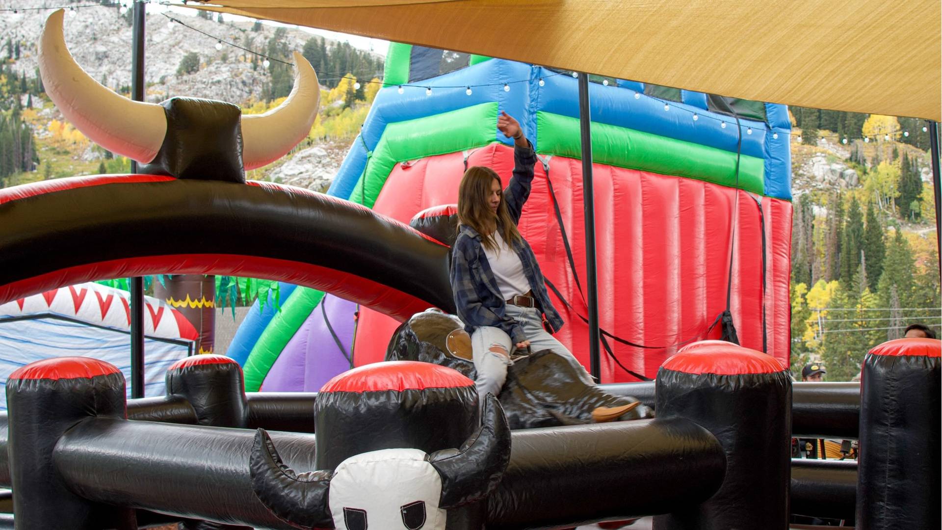 Girl on mechanical bull at Brighton Resort in the summer