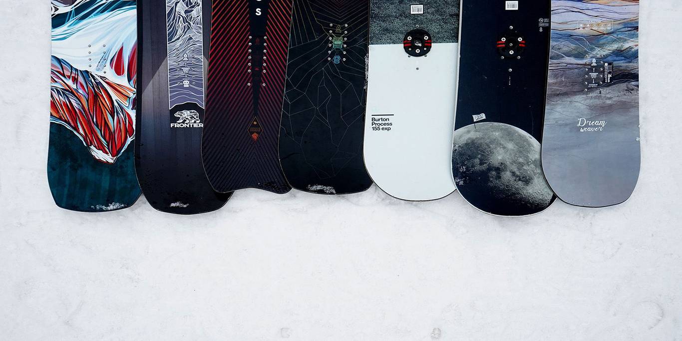 Salomon rental skis lined up in a rental ski shop.