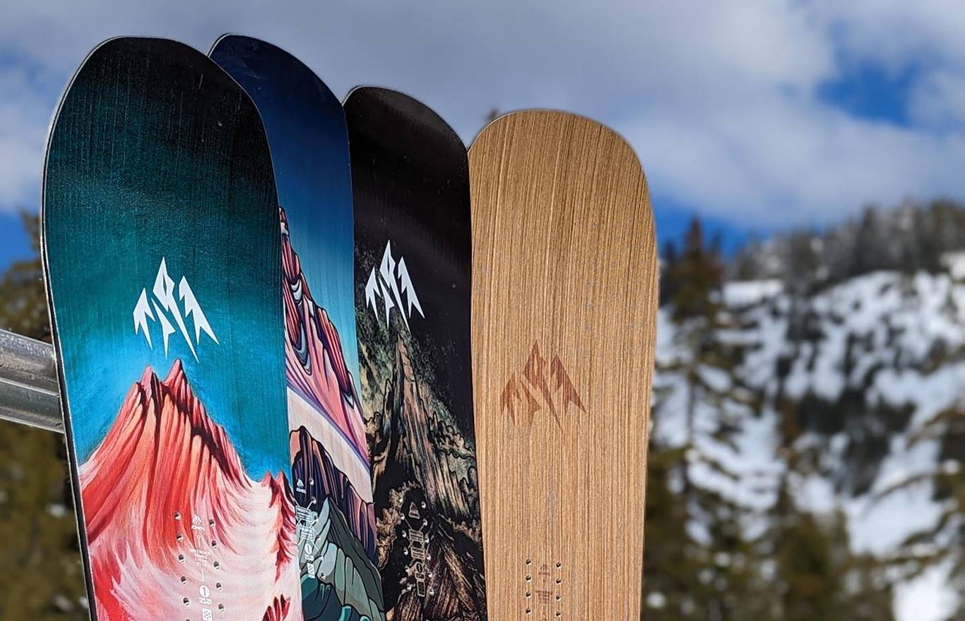 Boards leaning on racks with mountain in the background.