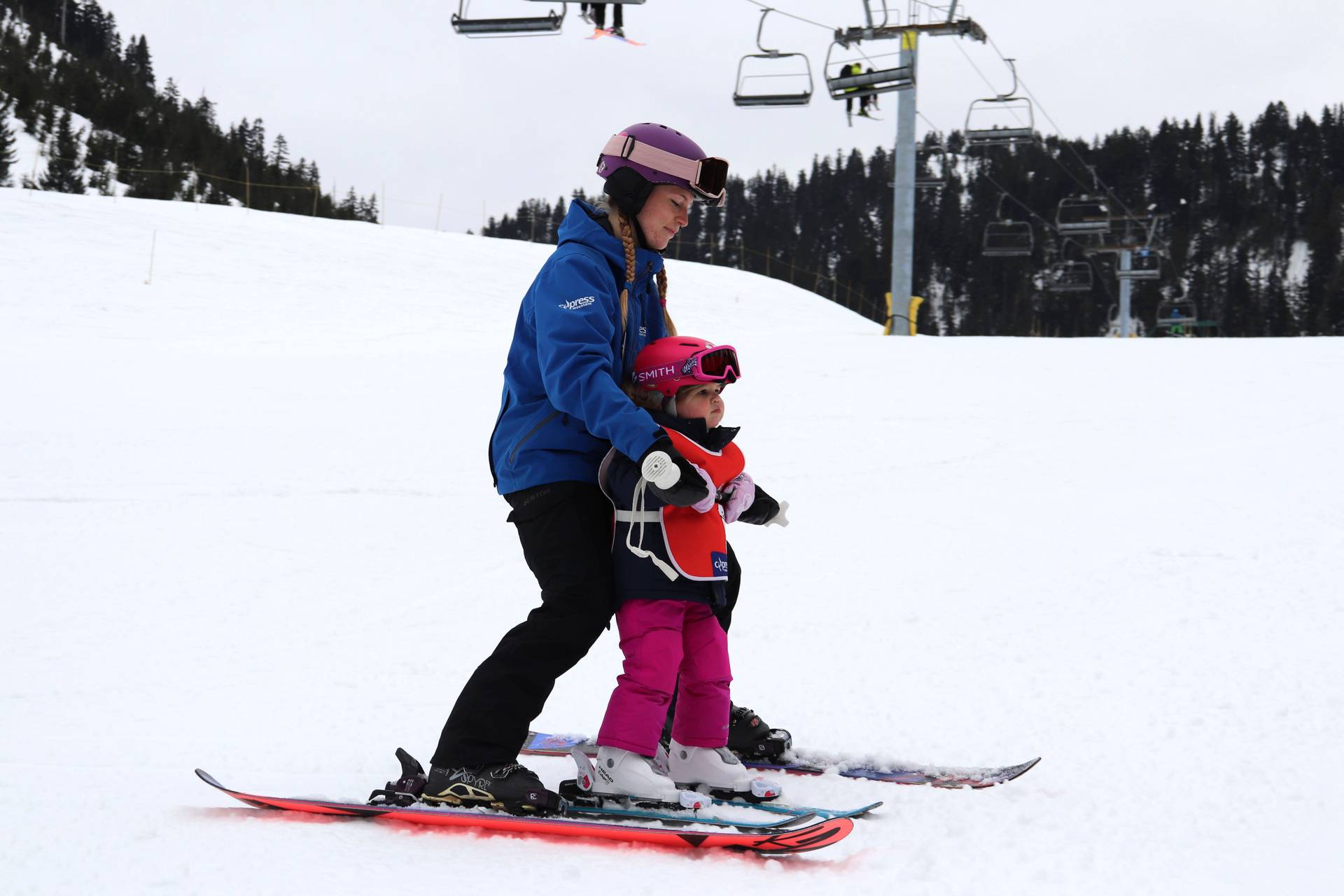 Ski instructor teaching a small kid