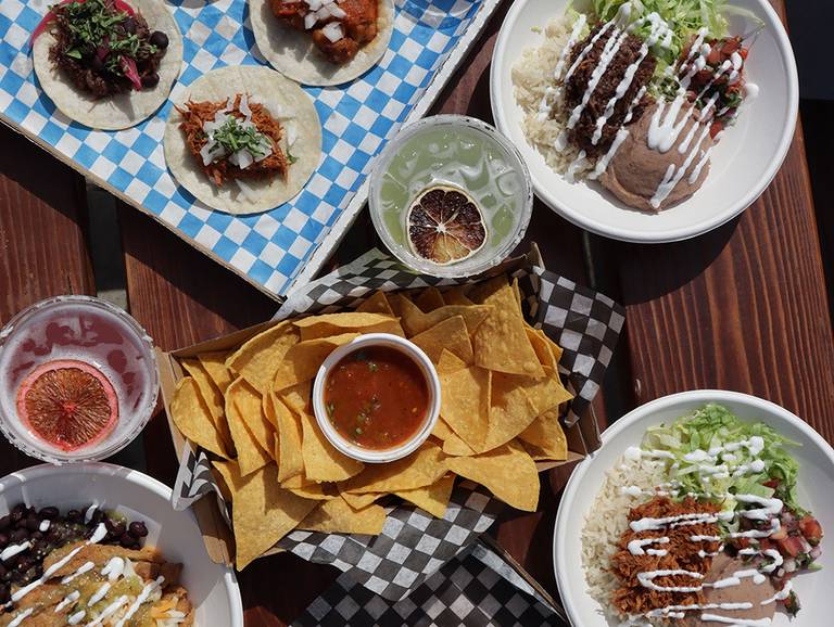 Mexican food laid out on a picnic table.