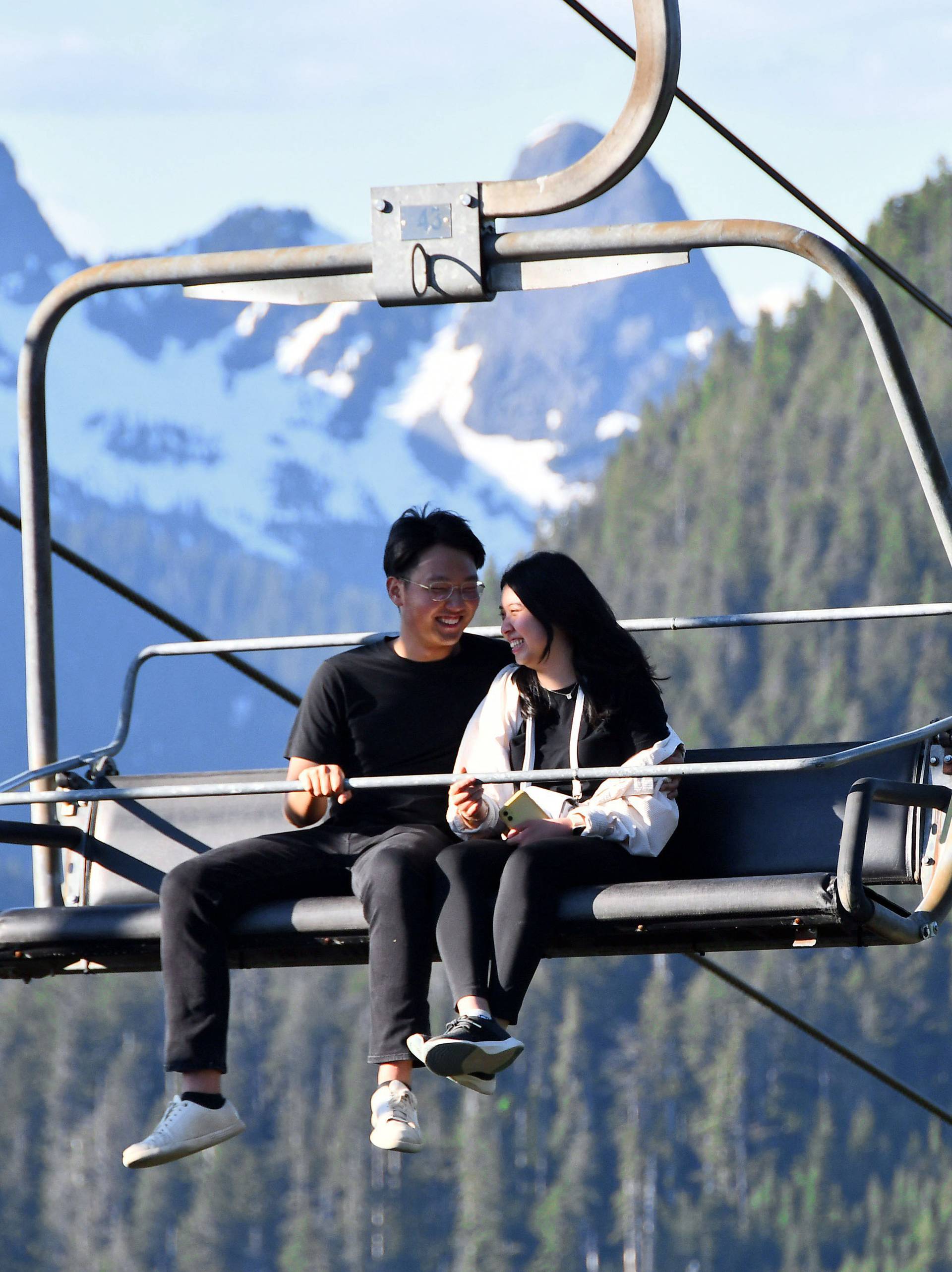 A couple on a chairlift during summer.