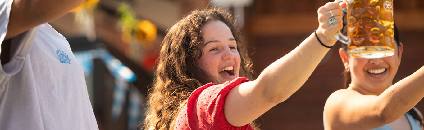 A group of people cheers at Cypress Mountain Oktoberfest celebration