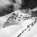 An alpine mountain peak in black and white.