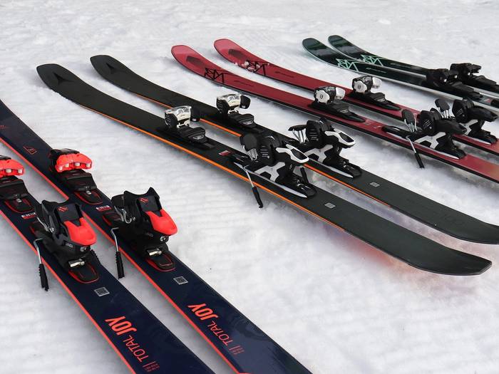 Four rental skis on snow.
