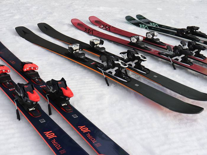 Four rental skis on snow.
