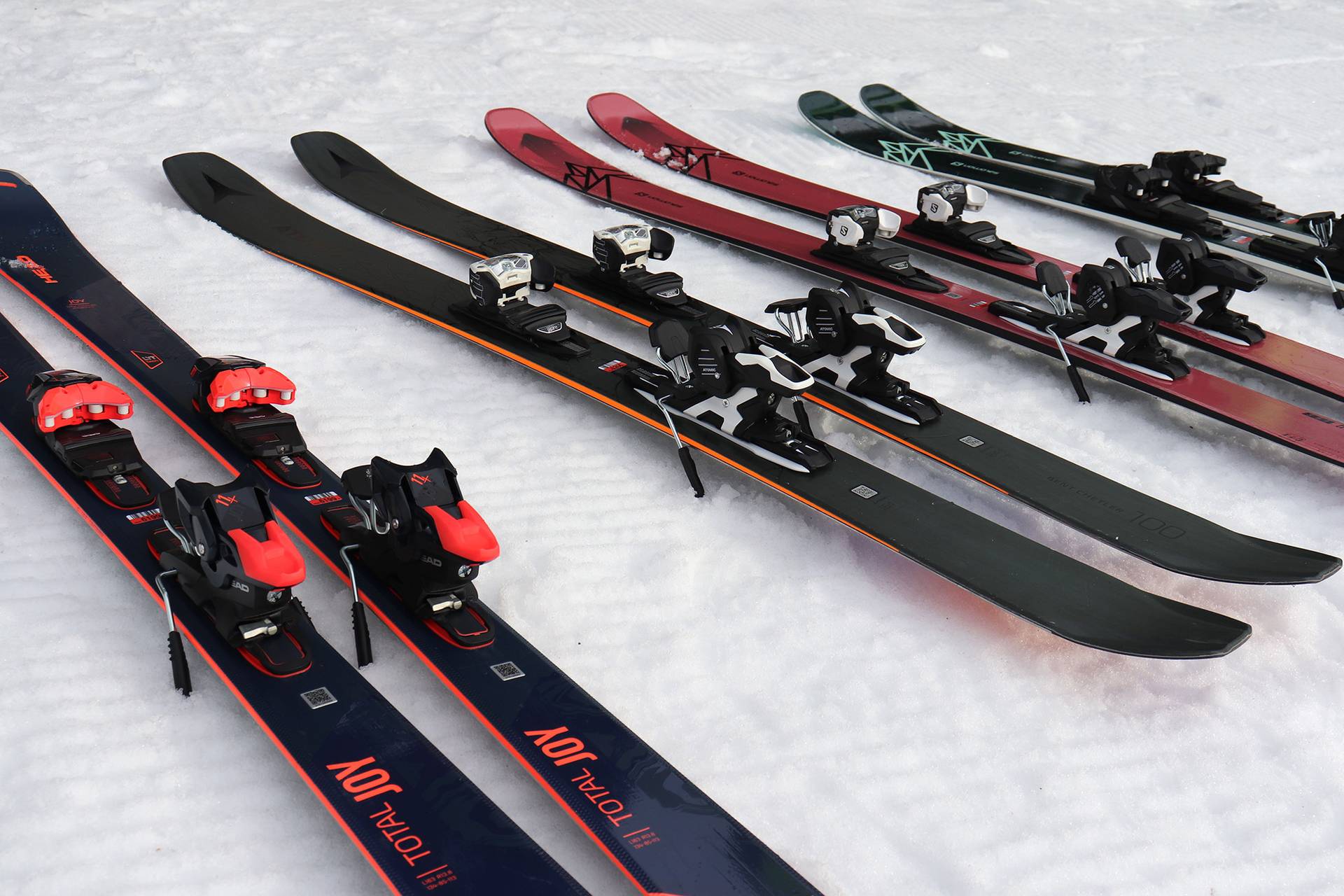 Ski sitting in the snow in parallel ready to be put on.