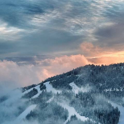 Black Mountain during sunset with clouds rolling in from the bottom.