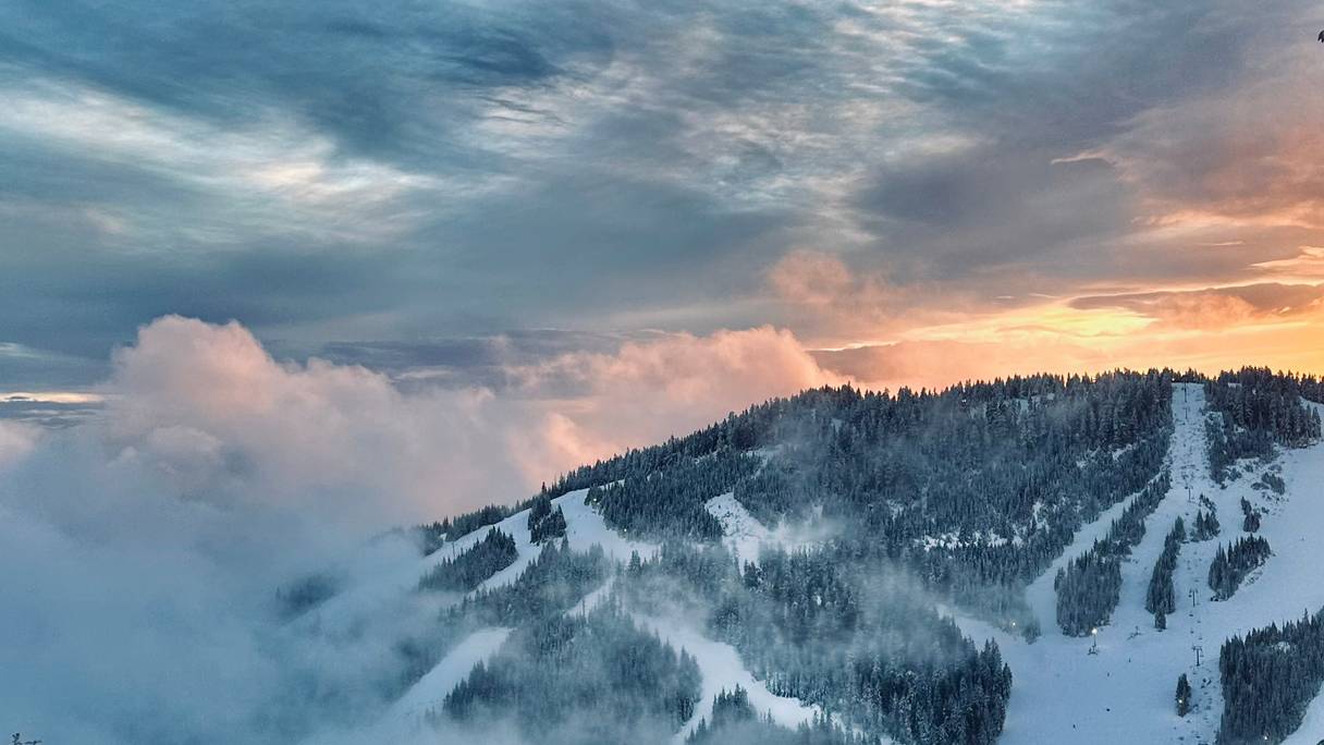 Black Mountain during sunset with clouds rolling in from the bottom.