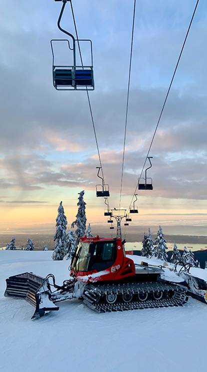 A snowcat under the chairlift.