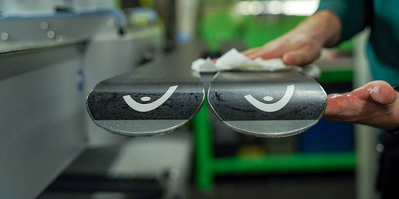 rental employee waxing and tuning Atomic skis.