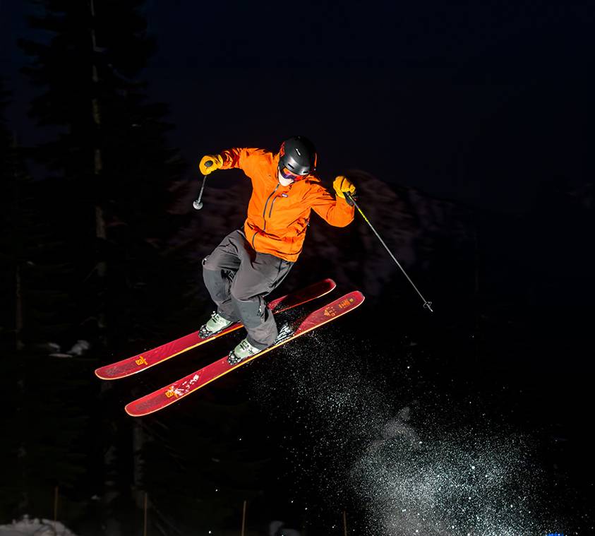 Skier performing a jump at night