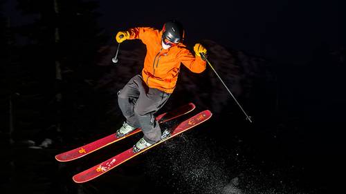 Skier performing a jump at night