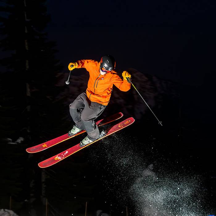 Skier performing a jump at night