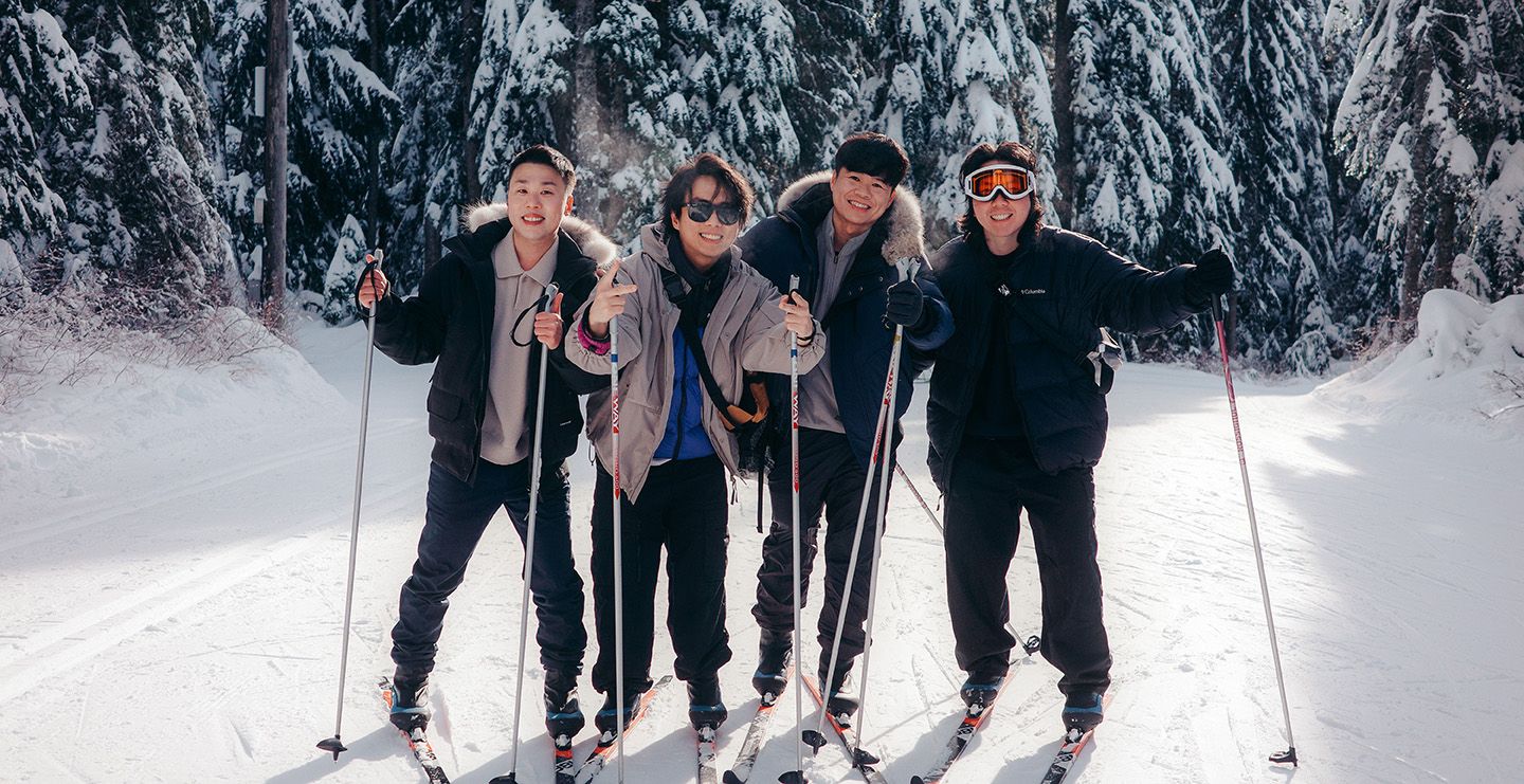 Group of cross country skiers posing for the camera on a sunny day.