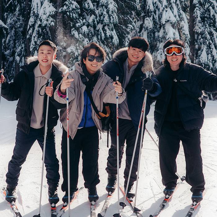 Group of cross country skiers posing for the camera on a sunny day.