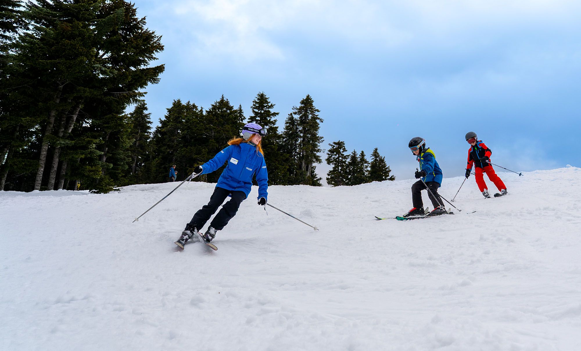 Ski instructor with two child students.