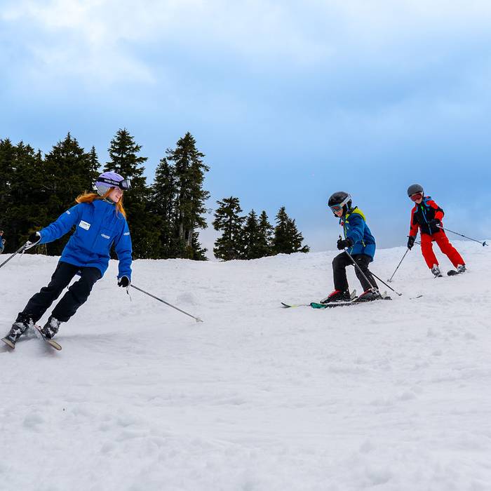 Ski instructor with two child students.
