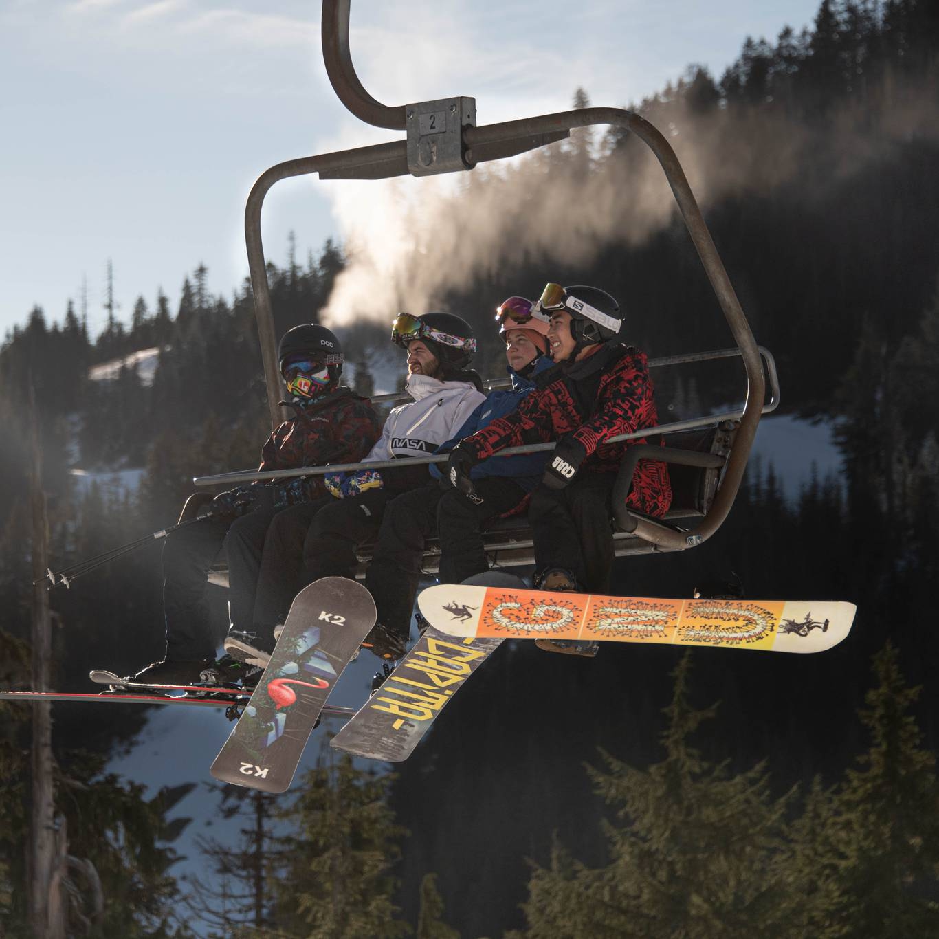 Snowboarders on a chairlift.