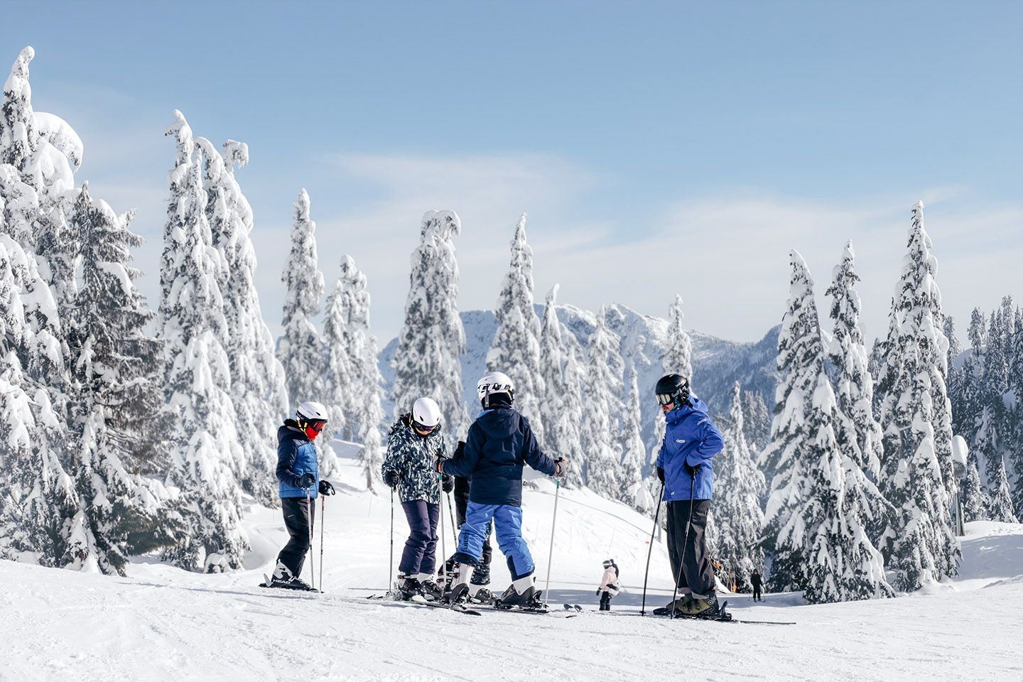 Ski instructor and youth students on snow.