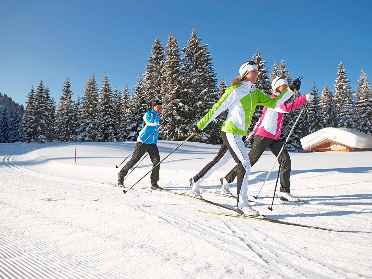 A group of women cross country skiing.