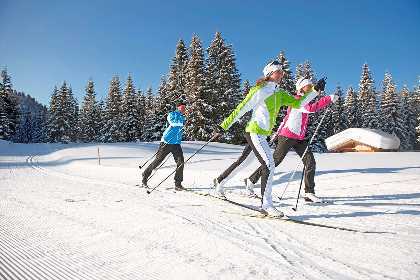 A group of women cross country skiing.