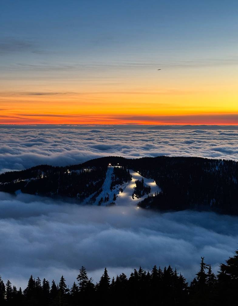 Black Mountain above the clouds during sunset.