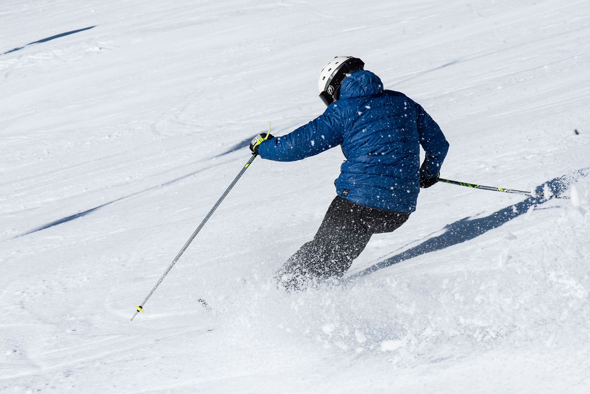 A person in blue jacket skiing.