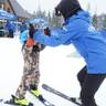 Skier jumping through powder