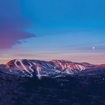 An aerial view of a ski resort at sunset.
